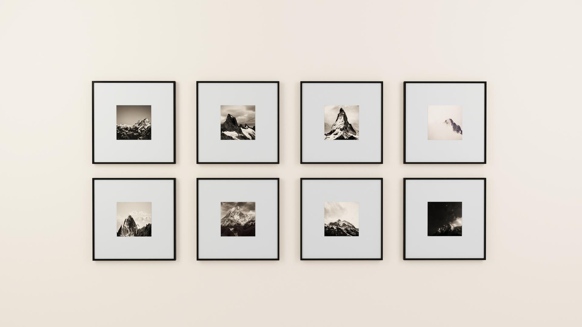 Gallery wall with mountain photographs in black frames